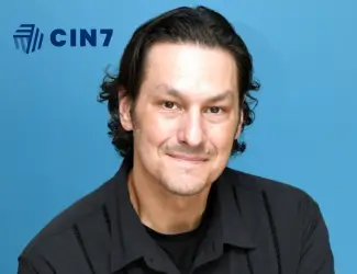 Portrait of Josh Fischer, VP of Cin7, against a blue background with the Cin7 logo, highlighting his insights on why Shopify is the best fit for SAP Business One integration.