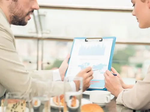 Two business professionals reviewing vendor ecosystem data as part of an  evaluation.