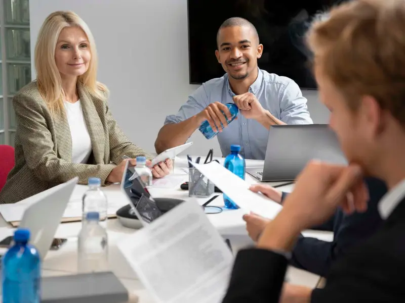 Team of professionals discussing an ERP checklist for businesses in a modern office setting.