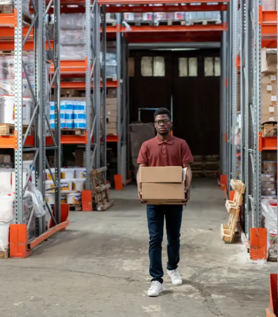 A worker standing in a warehouse aisle, highlighting common challenges in wholesale distribution operations and how ERP solutions can address them.